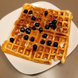 belgian yeast waffle with syrup and blueberries