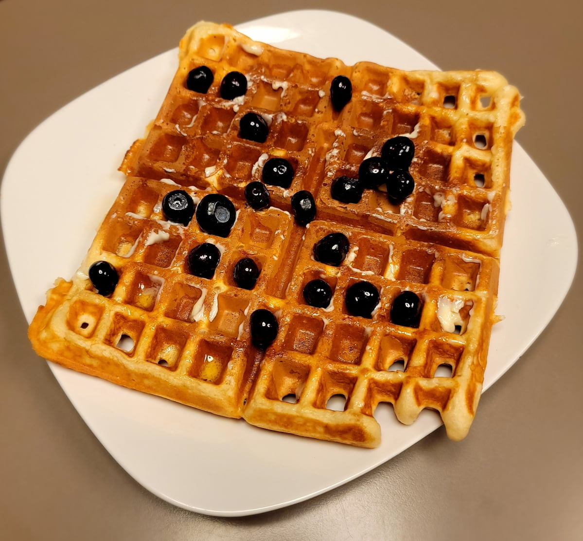 belgian yeast waffle with syrup and blueberries